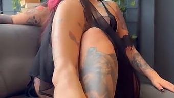 A Sexually Aroused Woman With Tattoos Displaying Her Physique