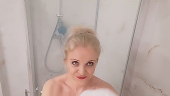 Older Blonde With Large Breasts Enjoys A Hot Shower